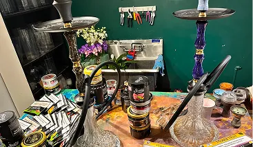 Hookah setup table with premium tobacco flavors and prepared hookahs for rental in New York