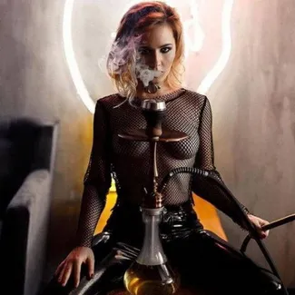 Woman with a glass hookah and hose sitting in front of a neon light, what is shisha hookah